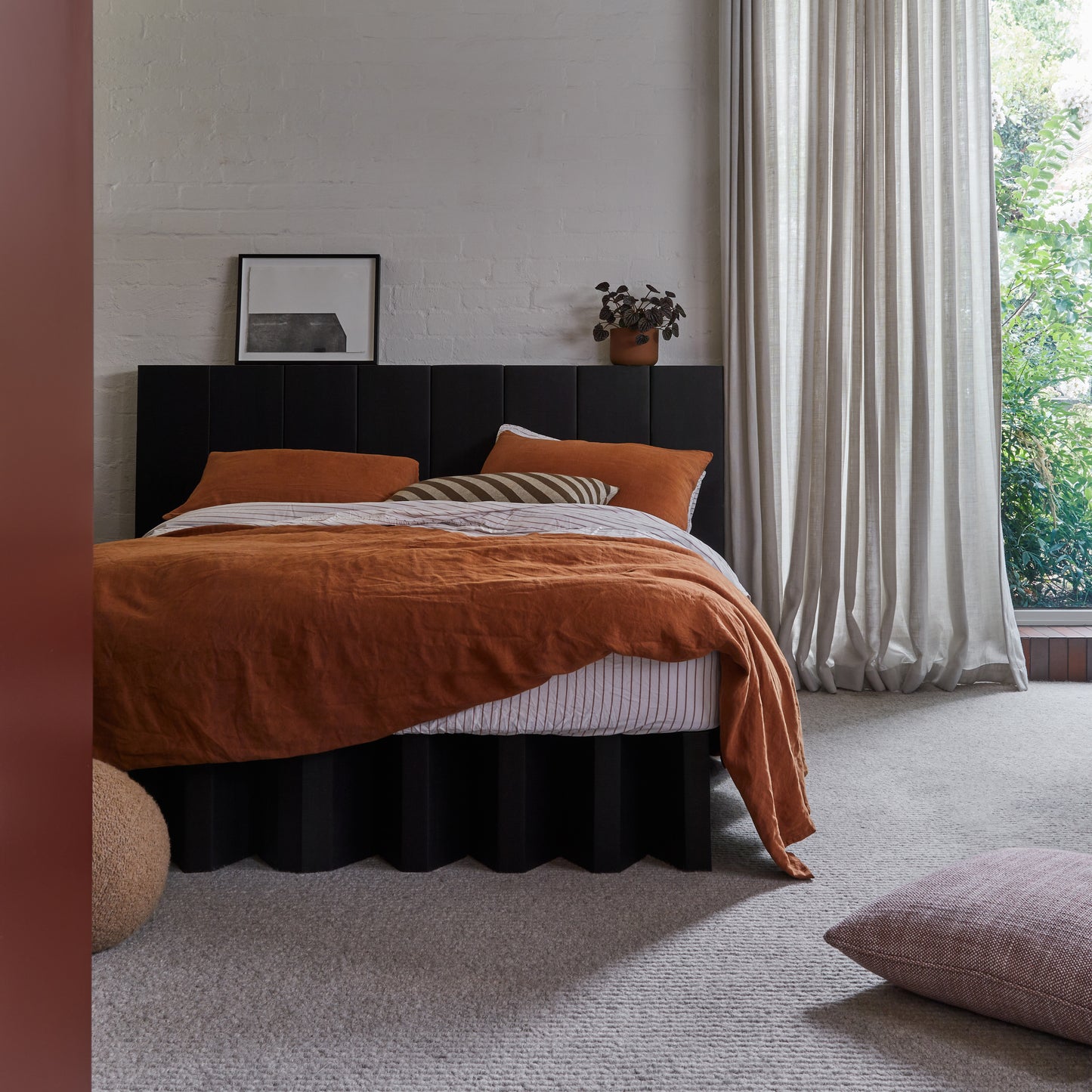 Yona bed base in black finish with headboard in a chic bedroom