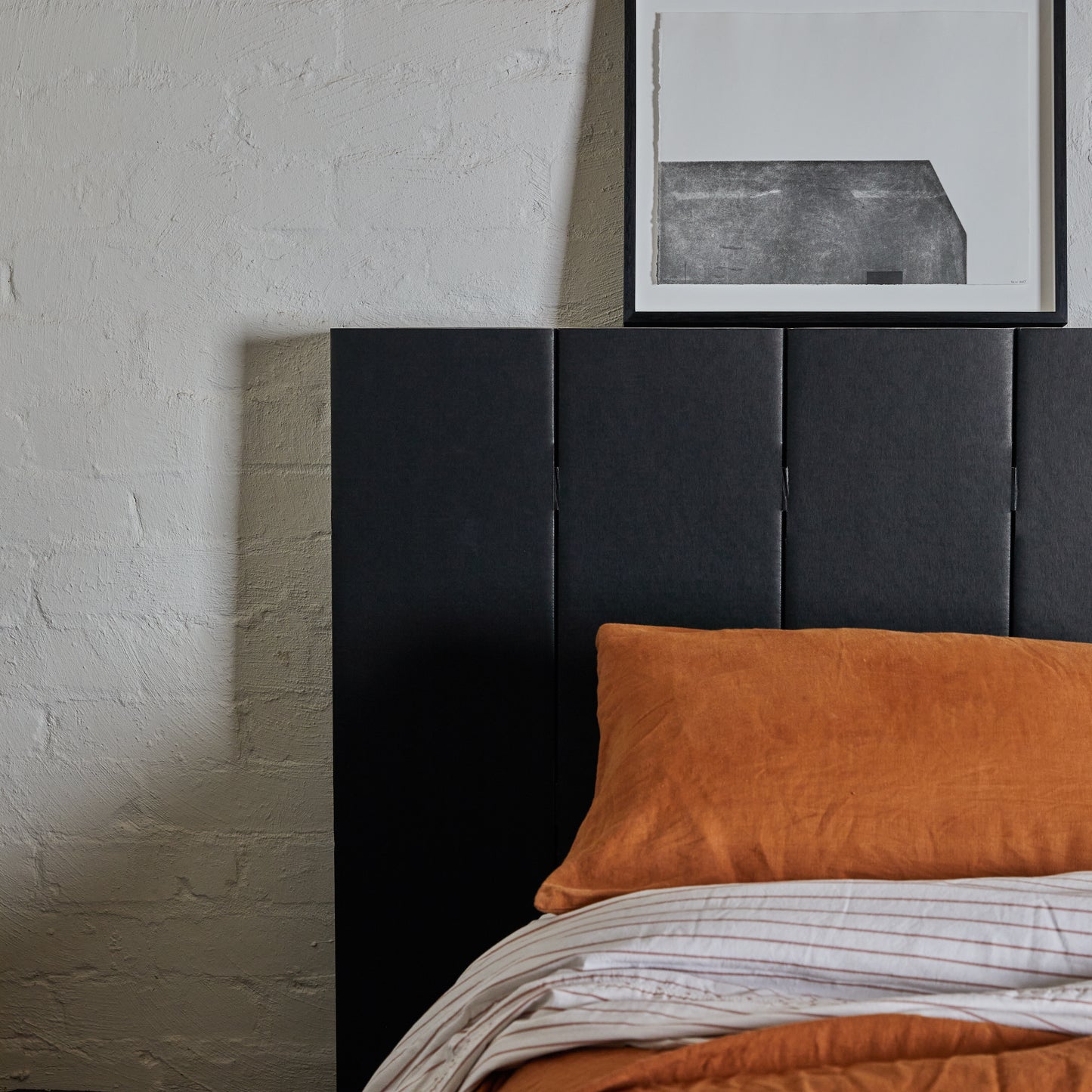 Close up photo showing the sleek design of Yona headboard in black finish